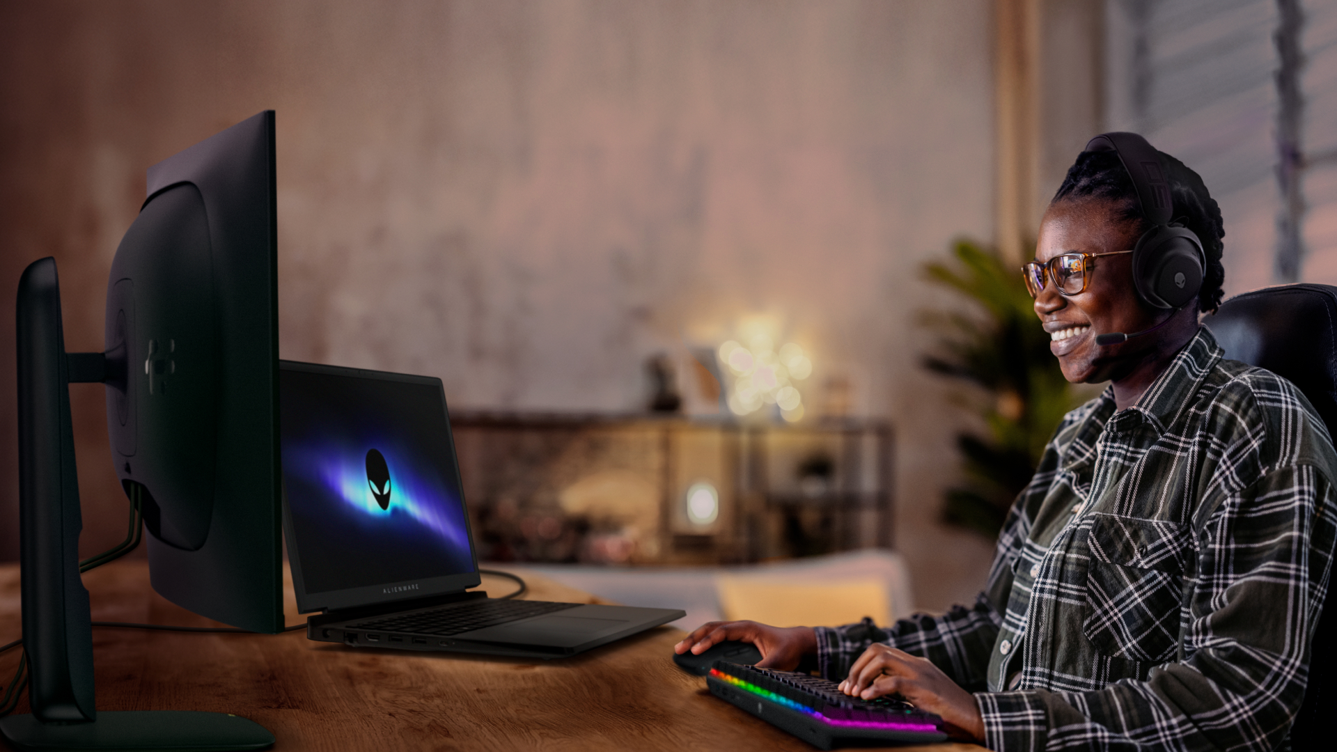 A person plays a game on their Alienware 15 laptop