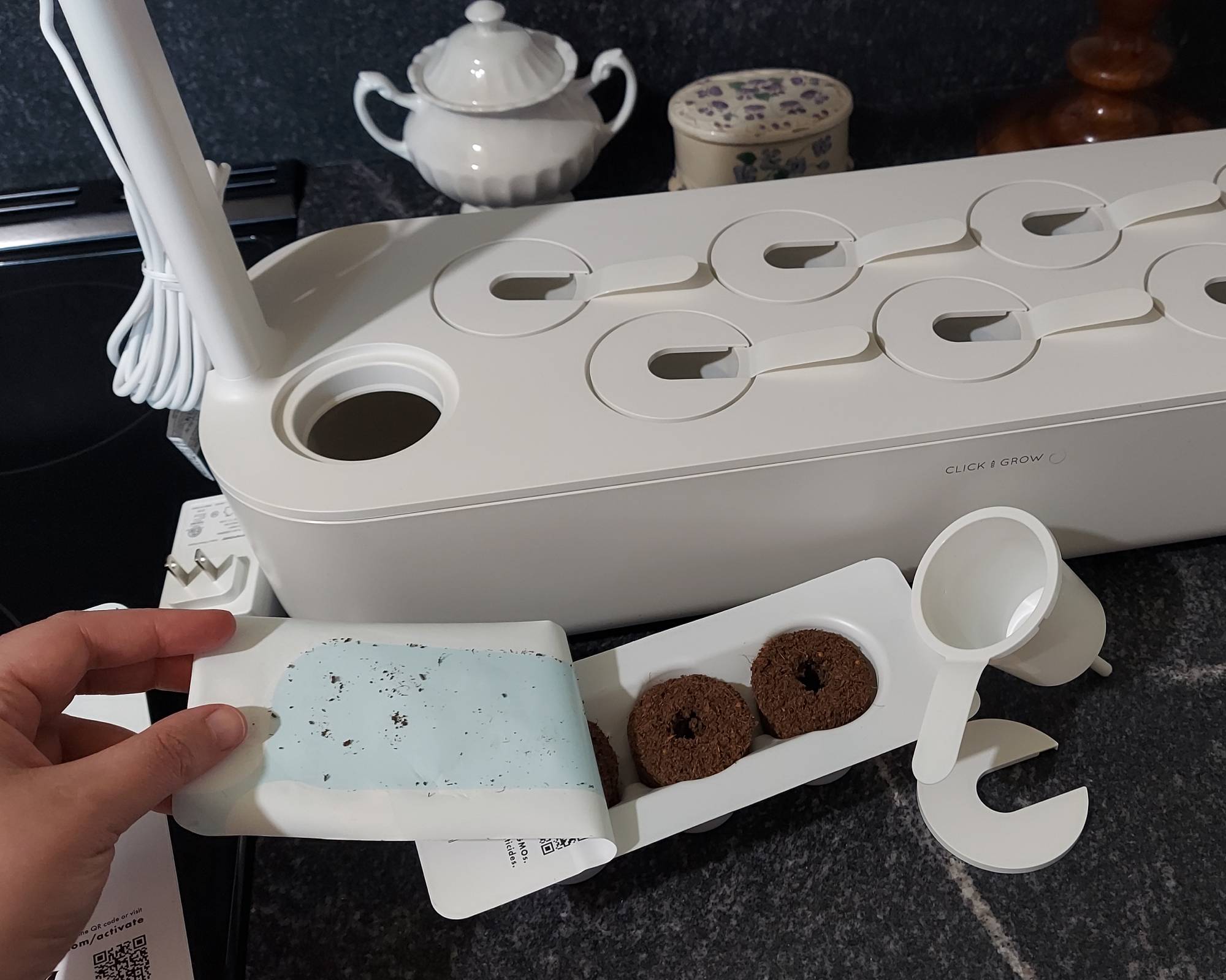 Gardener preparing planting pods for grow kit