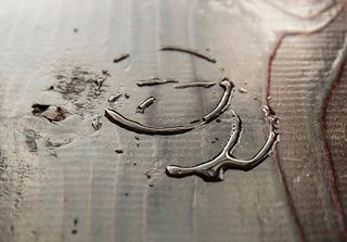 Three quarters view of water rings on a dark wood surface with copy space