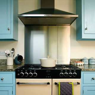 kitchen with blue coloured and cooker and chimney