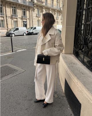 Influencer wears a cropped trench coat.