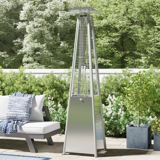 A silver pyramid Belfry Heating gas patio heater on a paved patio