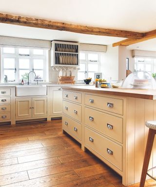 Cream drawers, wooden beam, white sink