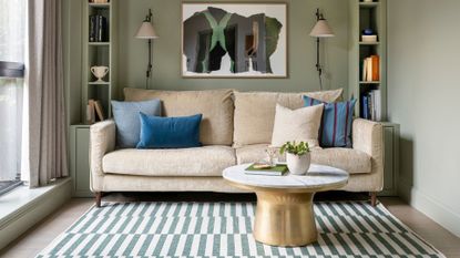 living room with neutral sofa, built in cabinetry and patterned rug to support expert advice on ways to update your living room for spring