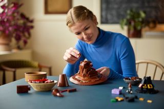 Adult woman assembling the LEGO Harry Potter Talking Sorting Hat