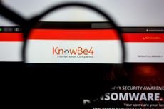 KnowBe4 logo on a screen under a microscope