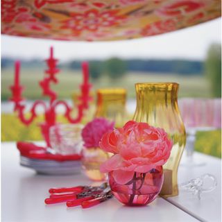 Flowers, lanterns and a candelabra on an outdoor table