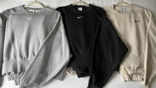 3 of valeza's nike tracksuits laid out