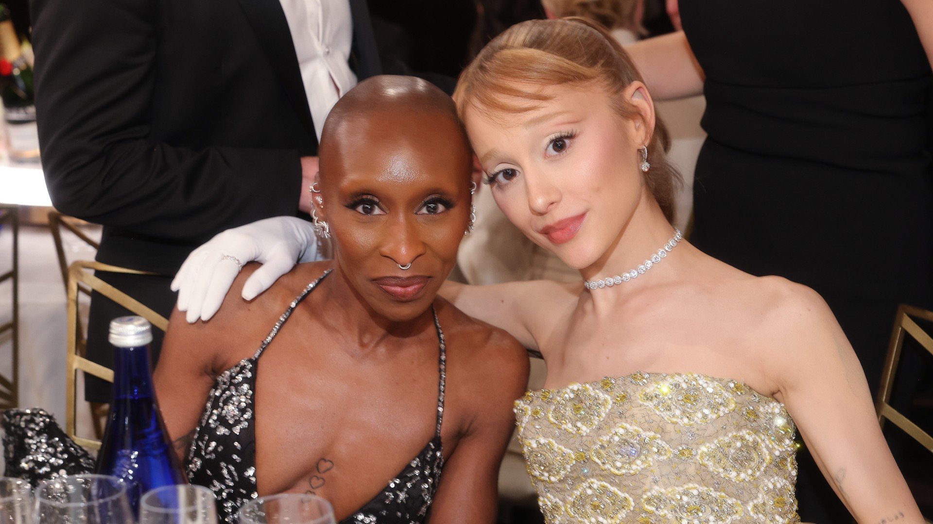 a photo of two women sitting next to each other at a table at an awards show