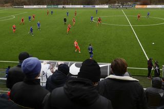 Supporters watch a match between Energetik BGU and BATE in Minsk on March 19