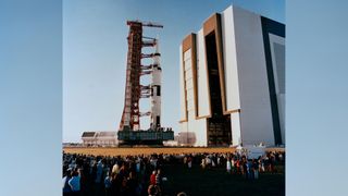 Spectators look on as the Apollo 16 space vehicle, standing 363-feel tall, consisting of Spacecraft 113, Lunar Module 11 and Saturn 511 moves out of the Vehicle Assembly Building 