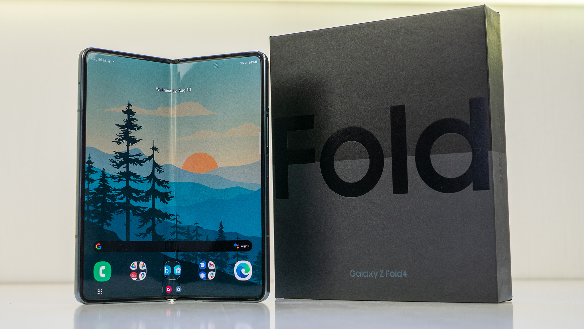 Samsung Galaxy Z Fold 4 in Graygreen next to the retail box