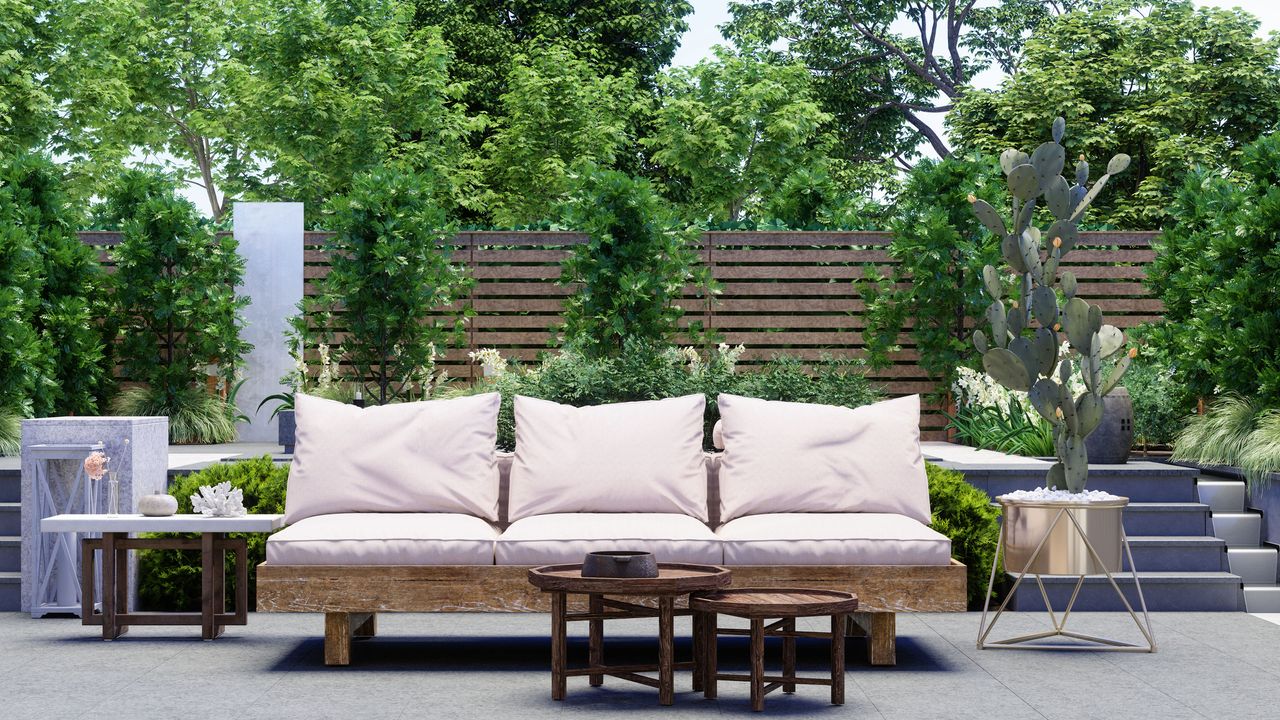 a backyard with a sofa and trees