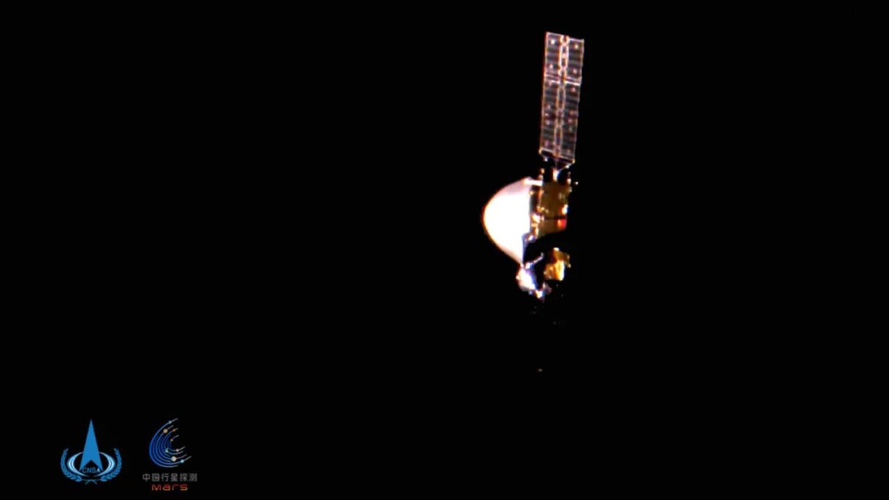 China's Tianwen-1 Mars probe is seen by a tiny camera ejected from the spacecraft in a photo captured 15 million miles (24 million kilometers) from Earth.