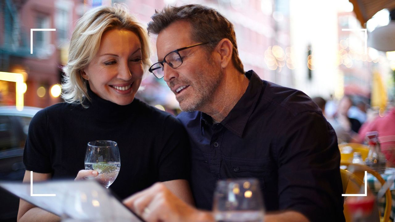 Man and woman sitting together having a romantic dinner, representing the tabletop sex position