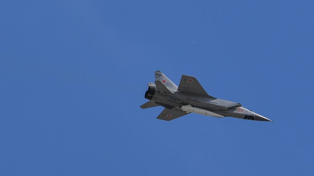 A Russian jet carrying a hypersonic missile flies over a military parade in Red Square, Moscow