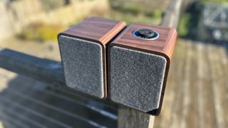 Ruark MR1 MkII speakers sitting on a wooden surface