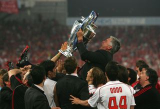 Carlo Ancelotti celebrates with the Champions League trophy after AC Milan's victory over Liverpool in 2007.
