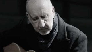 Pete Townshend playing an acoustic guitar