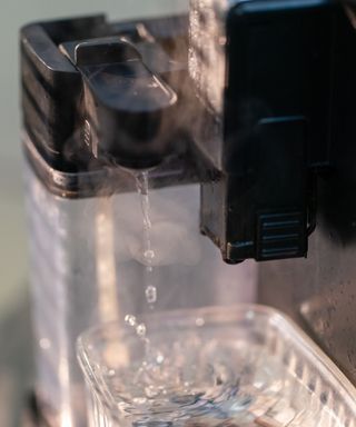 Cleaning a coffee maker with hot water