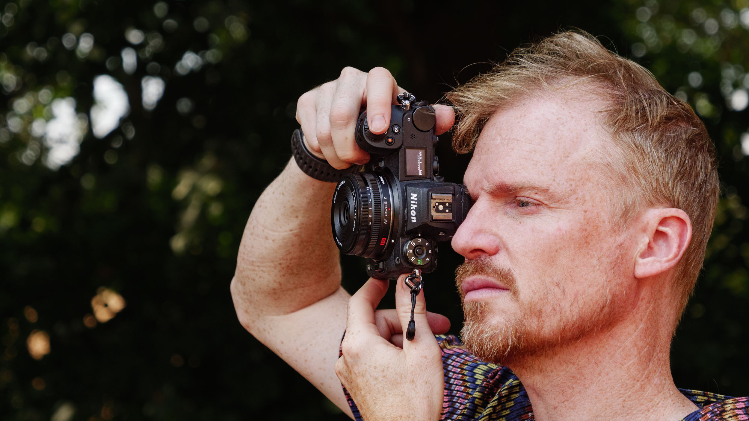 Viltrox AF 26mm F2.8 EVO 'pancake' lens attached to a Nikon mirrorless camera, photographer and TechRadar's Cameras Editor, Tim Coleman is holding the camera up to his eye