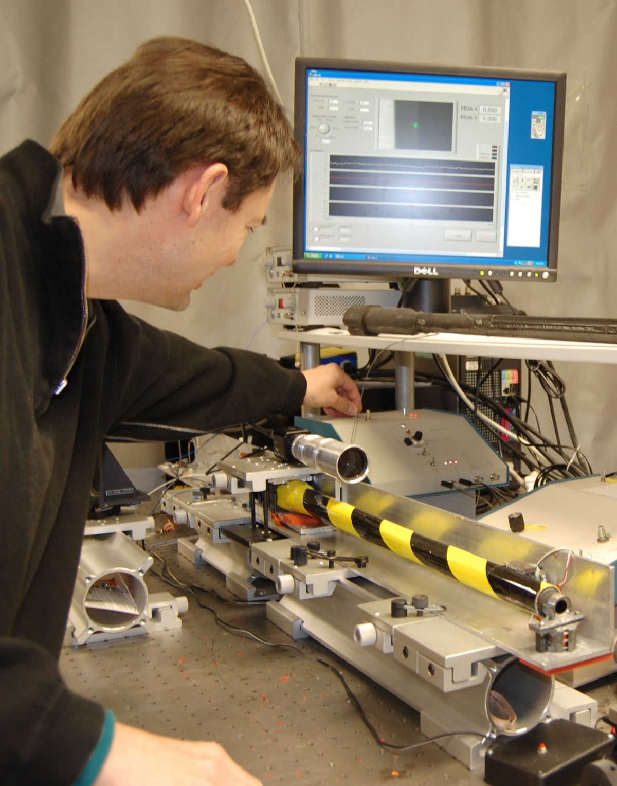 A laboratory prototype of the Reticle Compensating Rifle Barrel Reference Sensor allows Slobodan Rajic to fine-tune the technology. The system precisely measures the deflection of the barrel relative to the sight and then electronically corrects the sight