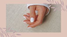 What are shellac nails? Hand with white shellac nails against linen background