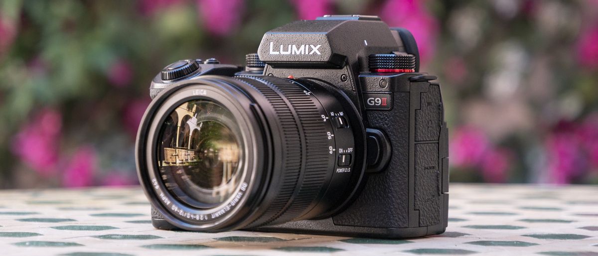 Panasonic Lumix G9 II camera on a patterned table with pink flower background