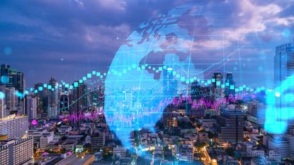 cityscape with double-exposure images of a globe and stock chart over top of it