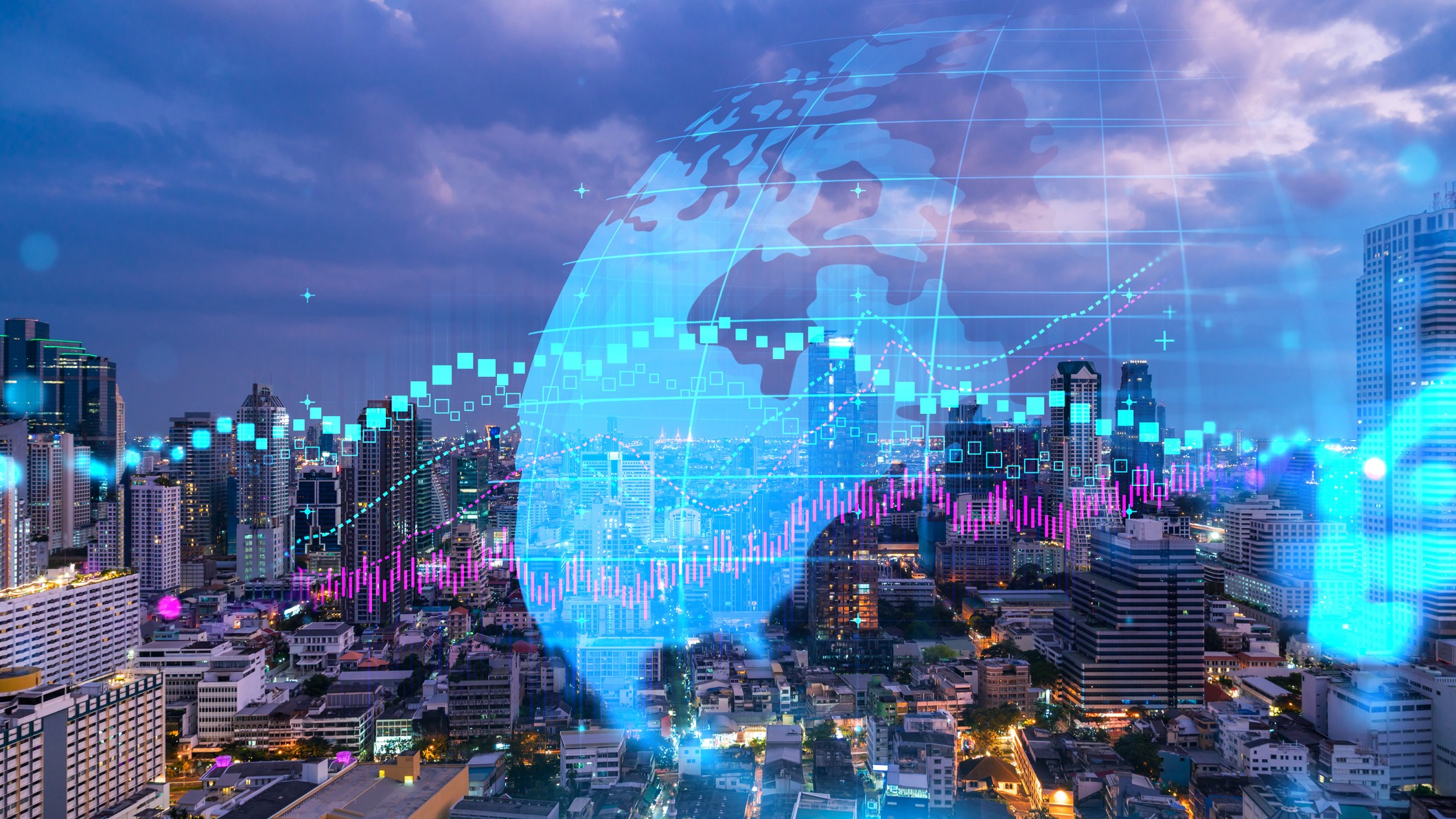 cityscape with double-exposure images of a globe and stock chart over top of it