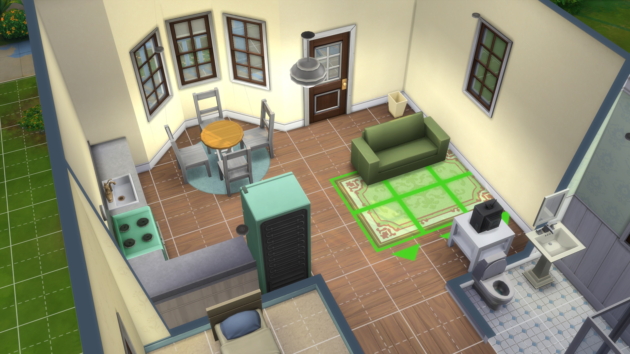 The Sims 4 build tips - In build mode, a rug being placed in a small living room.