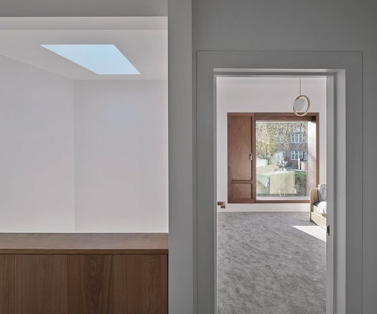 An upstairs hallway leading to a bedroom with a rooflight