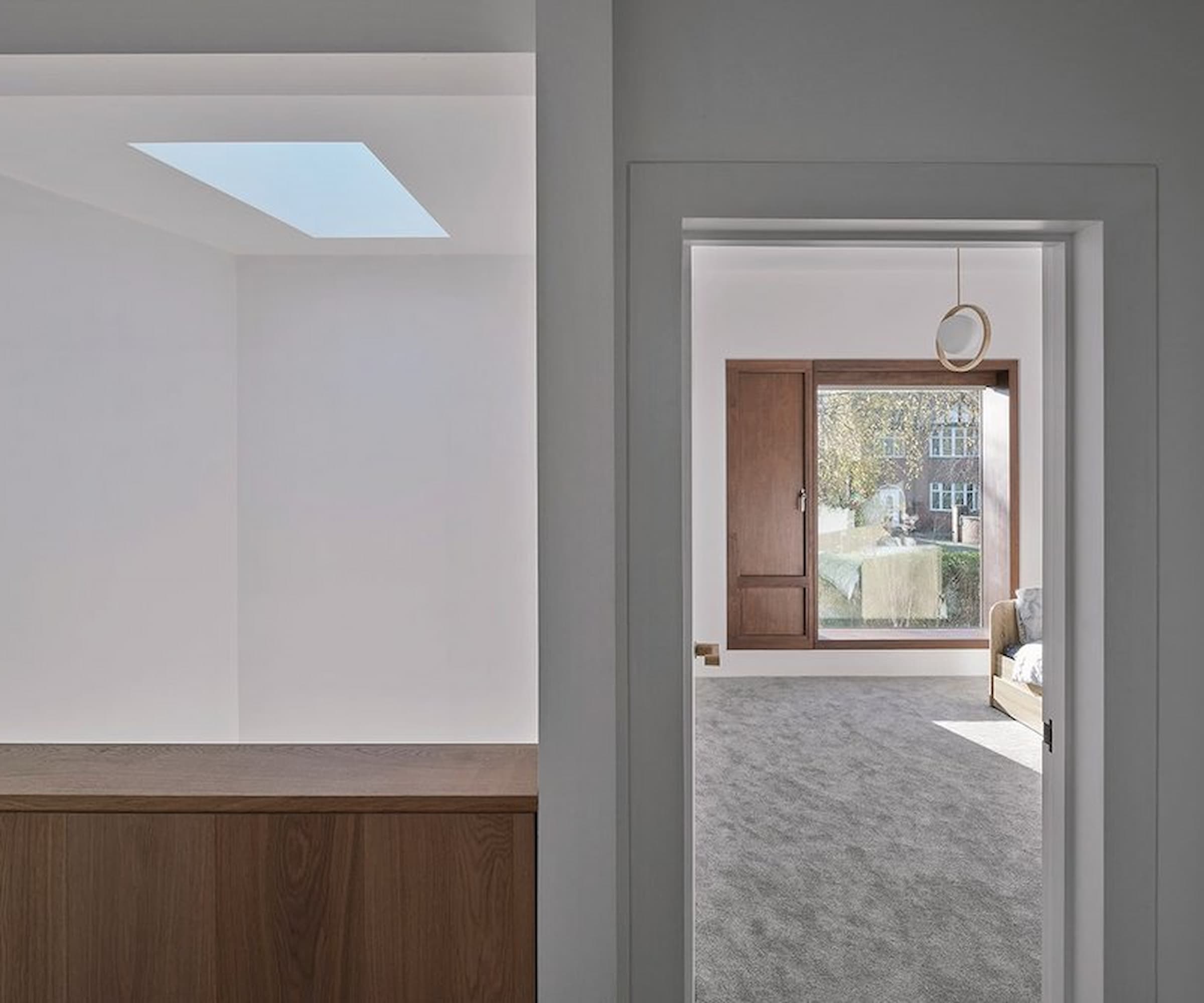 An upstairs hallway leading to a bedroom with a rooflight