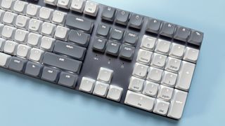 The Satechi SM3 mechanical keyboard against a blue background.