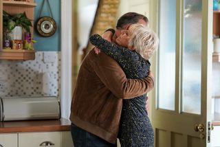 Harvey Monroe and Jean Slater hugging in the Slater house