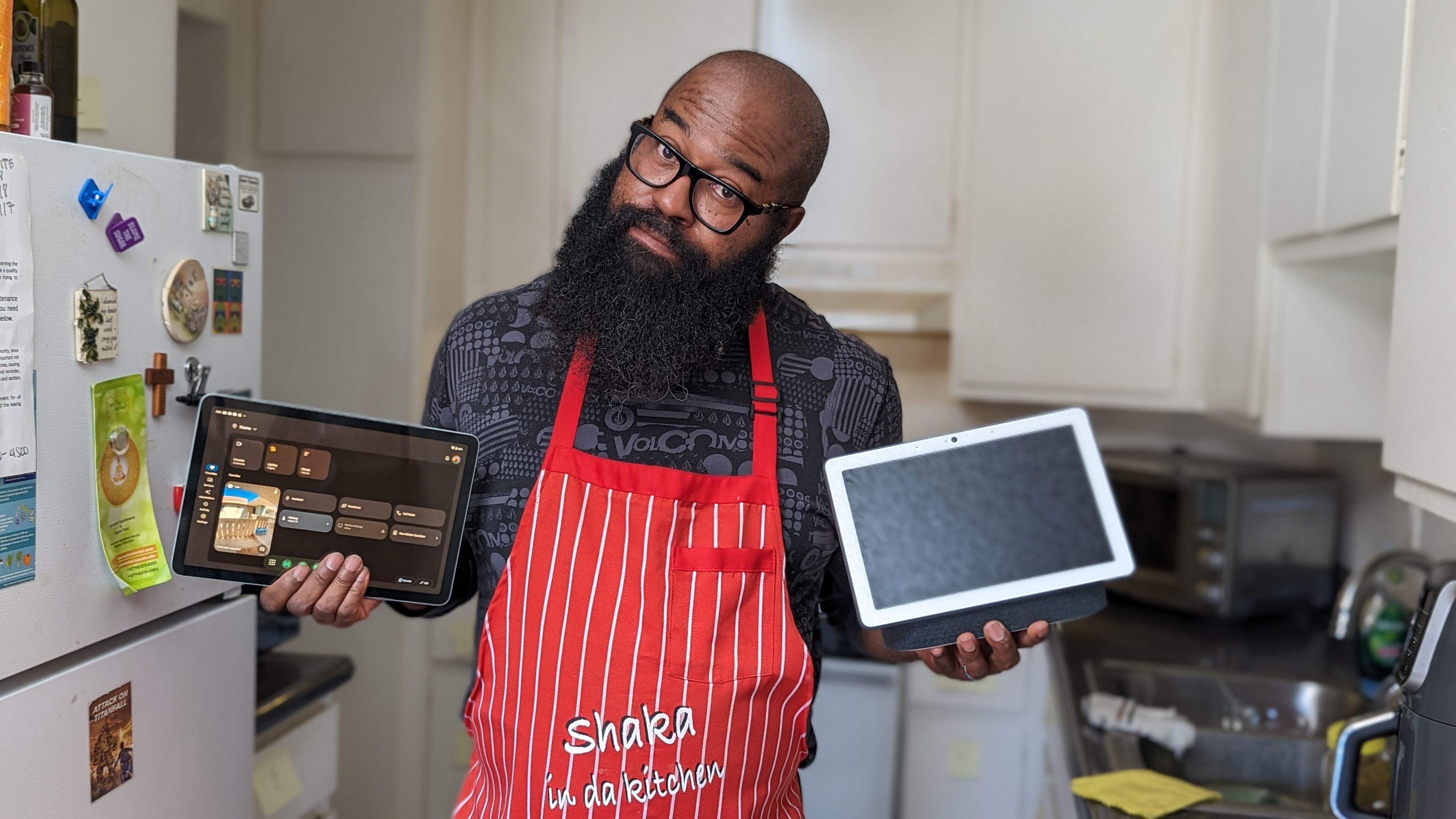 Tshaka holding up a Pixel Tablet and Nest Hub Max