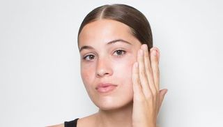 model moisturizing face before applying foundation