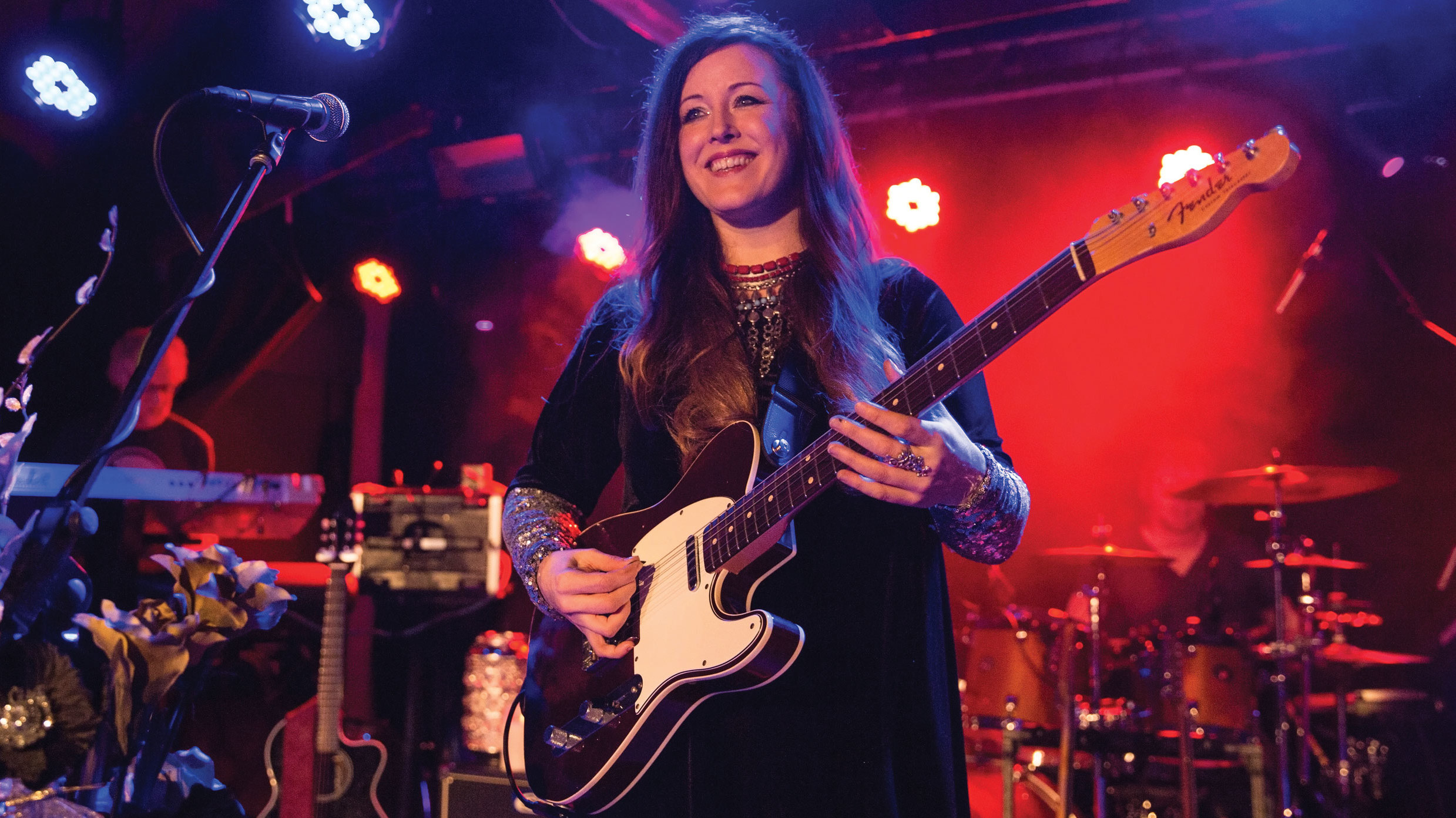 Panic Room&#039;s Anne-Marie Helder playing guitar on stage in Manchester