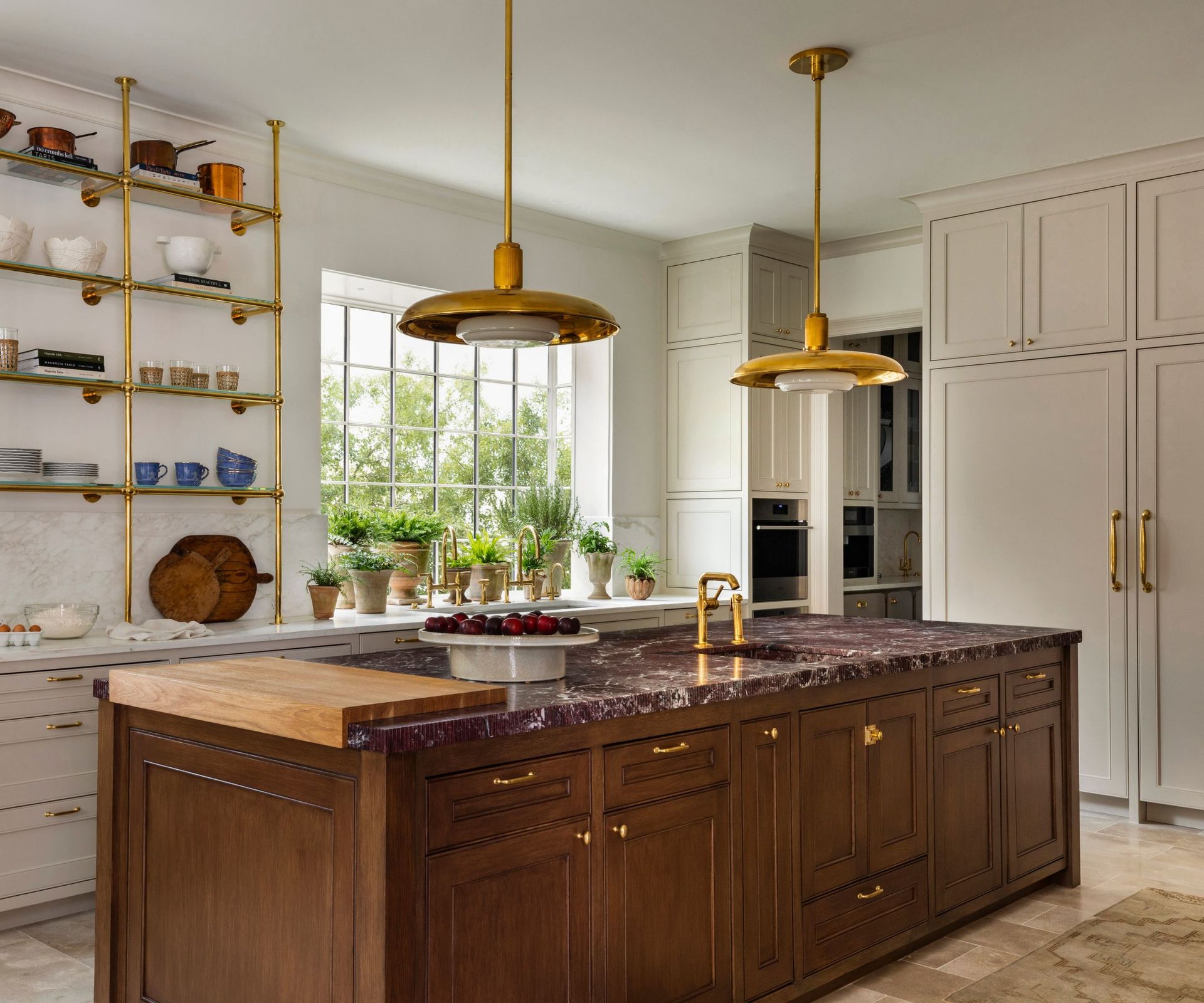 A neutral kitchen with a brown wood island
