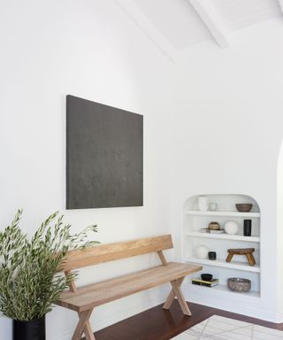Narrow entryway with white walls and raised ceiling