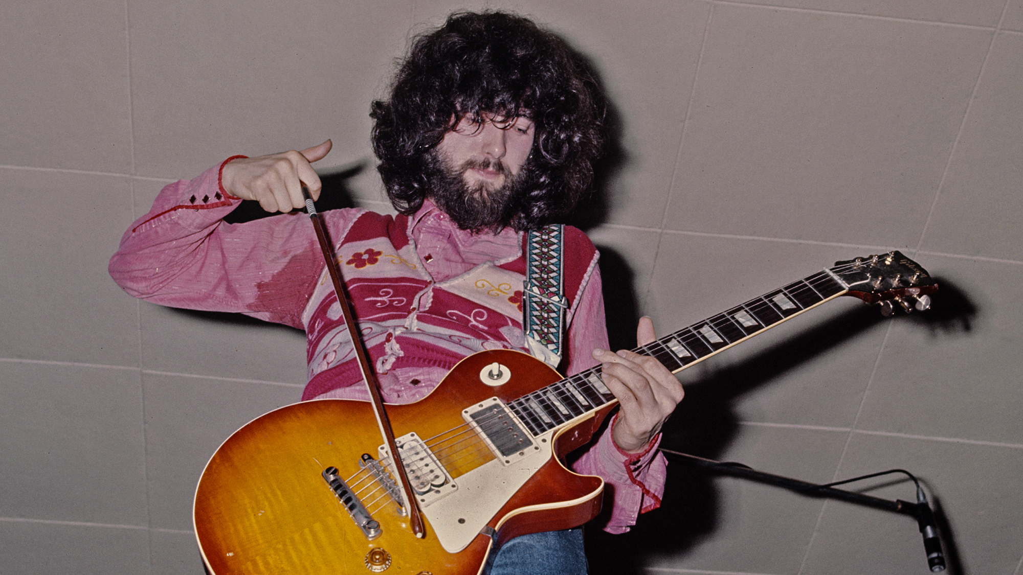 English guitarist and songwriter Jimmy Page of English rock group Led Zeppelin playing his Gibson Les Paul guitar with a violin bow, UK, 1969.