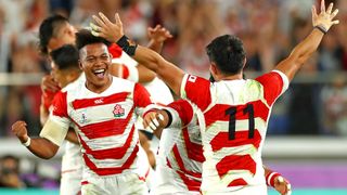 YOKOHAMA, JAPAN - OCTOBER 13: Kotaro Matsushima and Kenki Fukuoka of Japan celebrate victory after the Rugby World Cup 2019 Group A game between Japan and Scotland at International Stadium Yokohama on October 13, 2019 in Yokohama, Kanagawa, Japan.