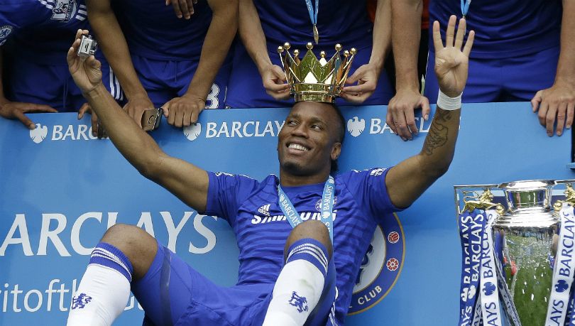 Didier Drogba celebrates one of his four Premier League titles with Chelsea