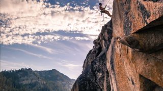 A young man rock climbing in the Sierra Nevada