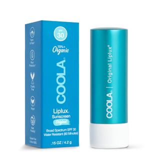 A blue tube of Coola Liplux organic lip balm with SPF 30