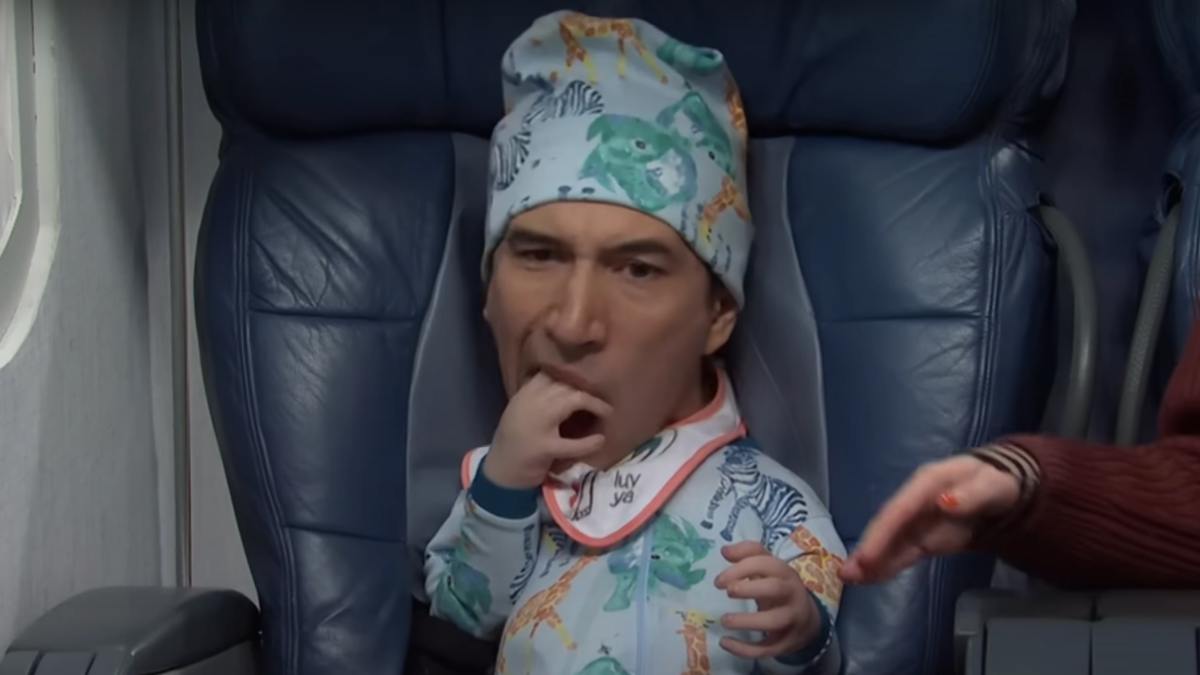 Adam Driver tries to eat his hand while dressed as a baby during an SNL sketch.