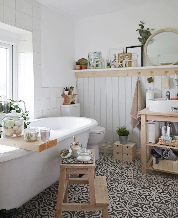 Ikea white bathroom idea with wall paneling, white bathtub, monochrome floor tiles and light wooden furniture