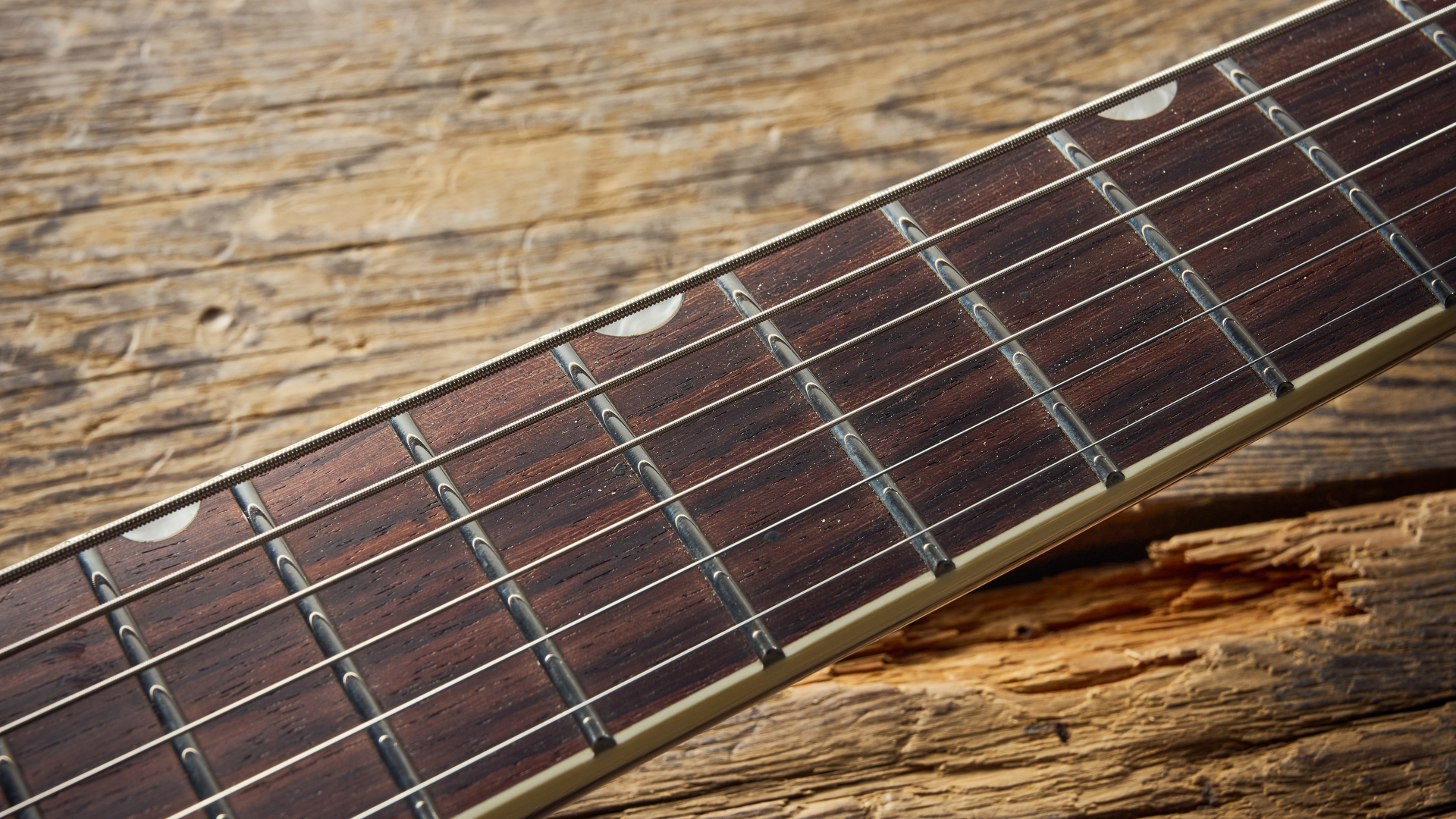 The rosewood fretboard of the Gretsch Electromatic Jet Baritone guitar