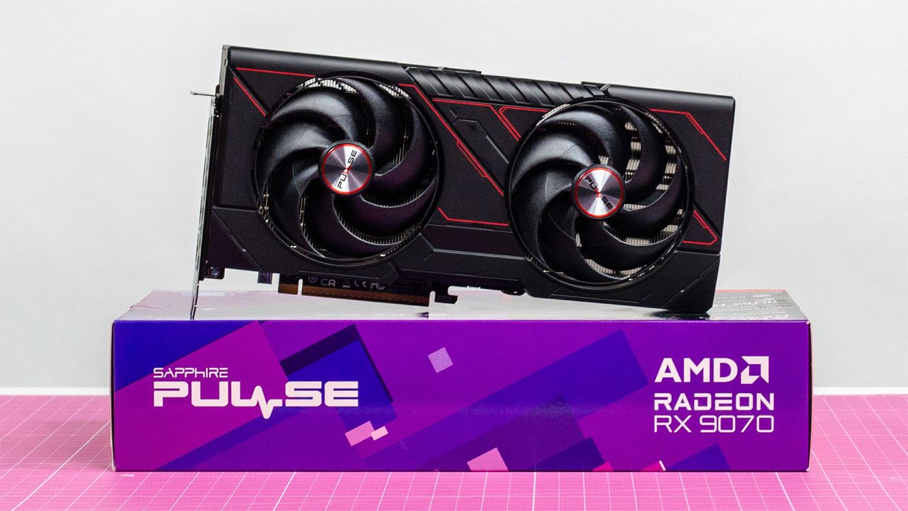 An AMD Radeon RX 9070 sitting on its retail packaging with its fans visible