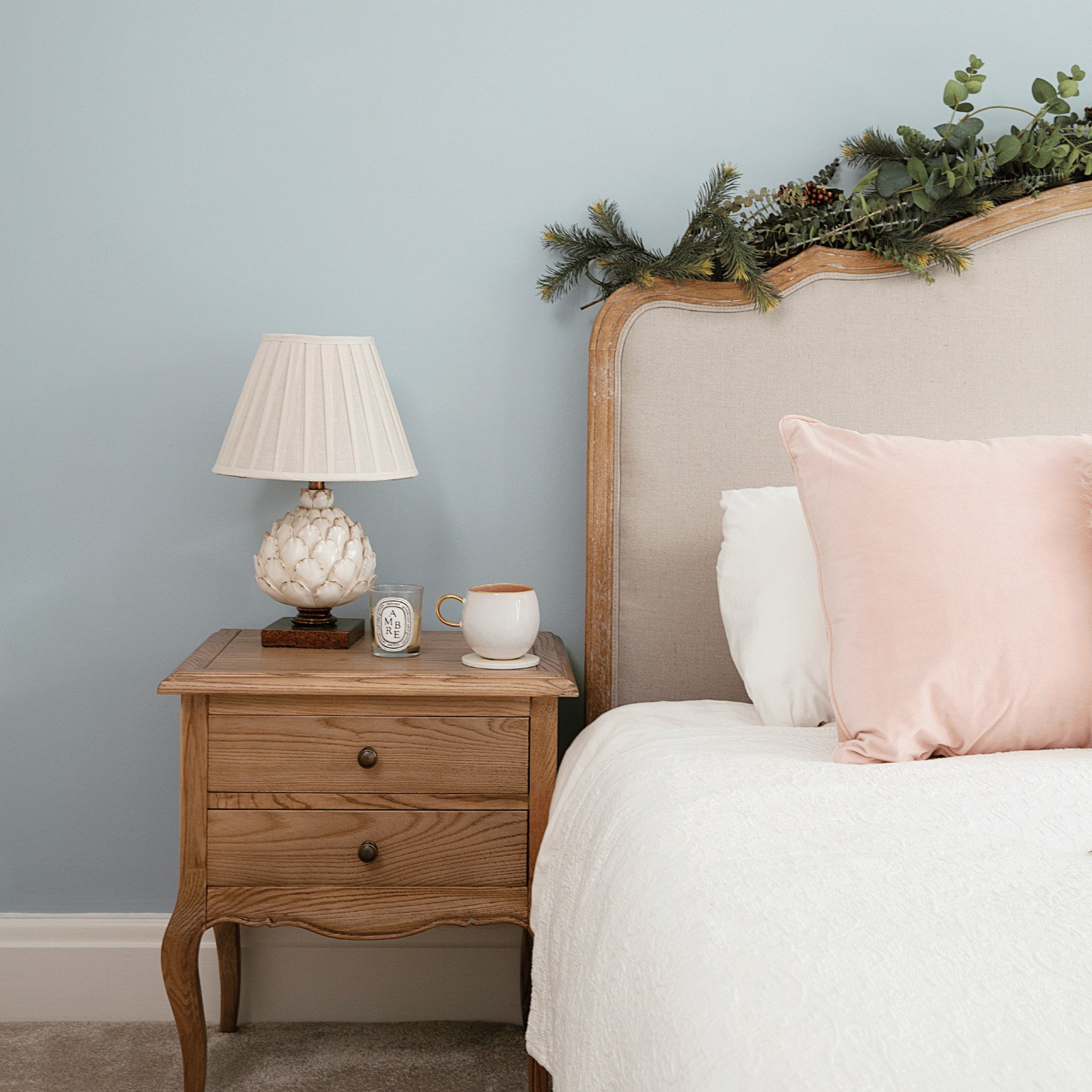 bedroom with blue wall wooden bed and wooden drawer